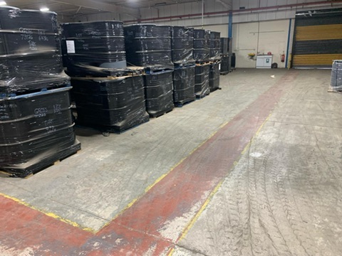 Hazardous material barrels wrapped and secured on pallets ready for export