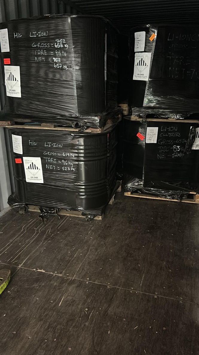 Properly wrapped and secured barrels loaded inside shipping container for international transit